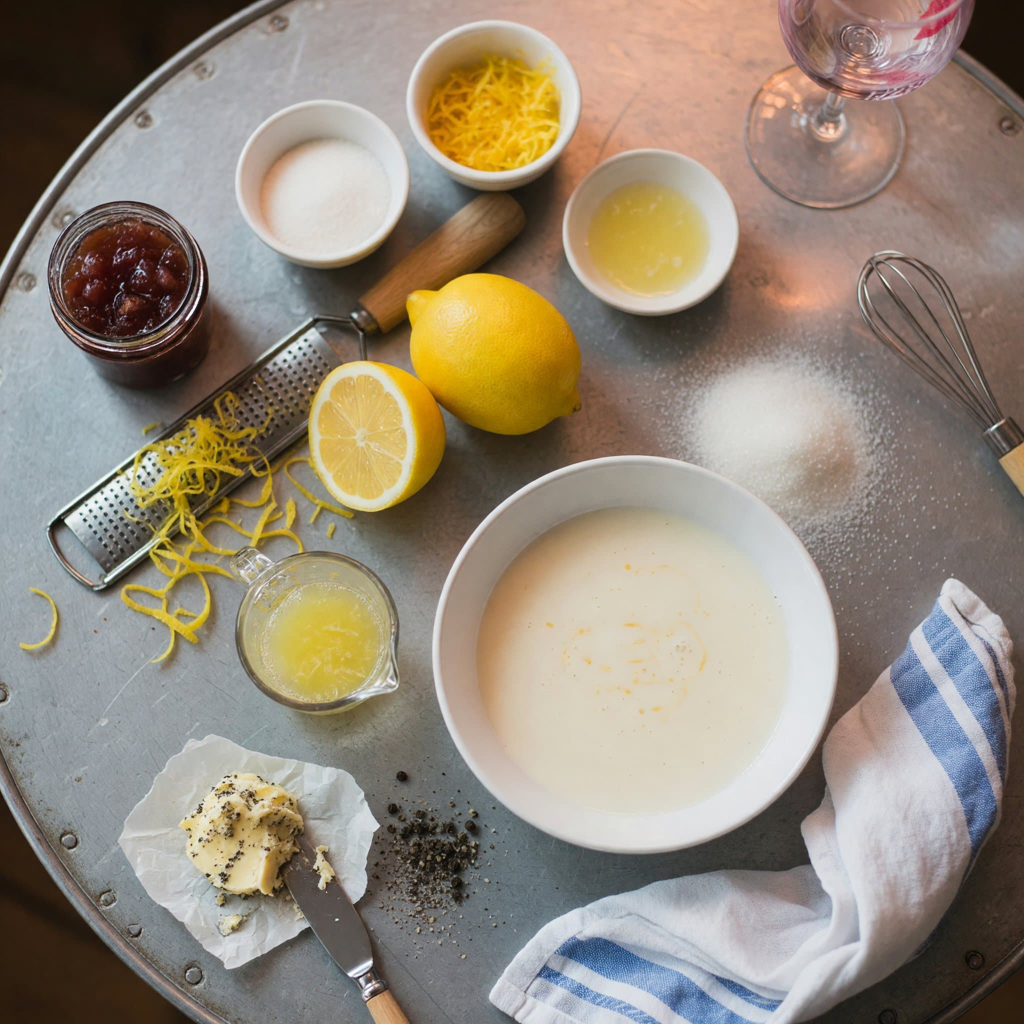 Overhead view of Lemons, lemon (zest), Lemon Juice, Heavy Cream and Granulated Sugar arranged on a table