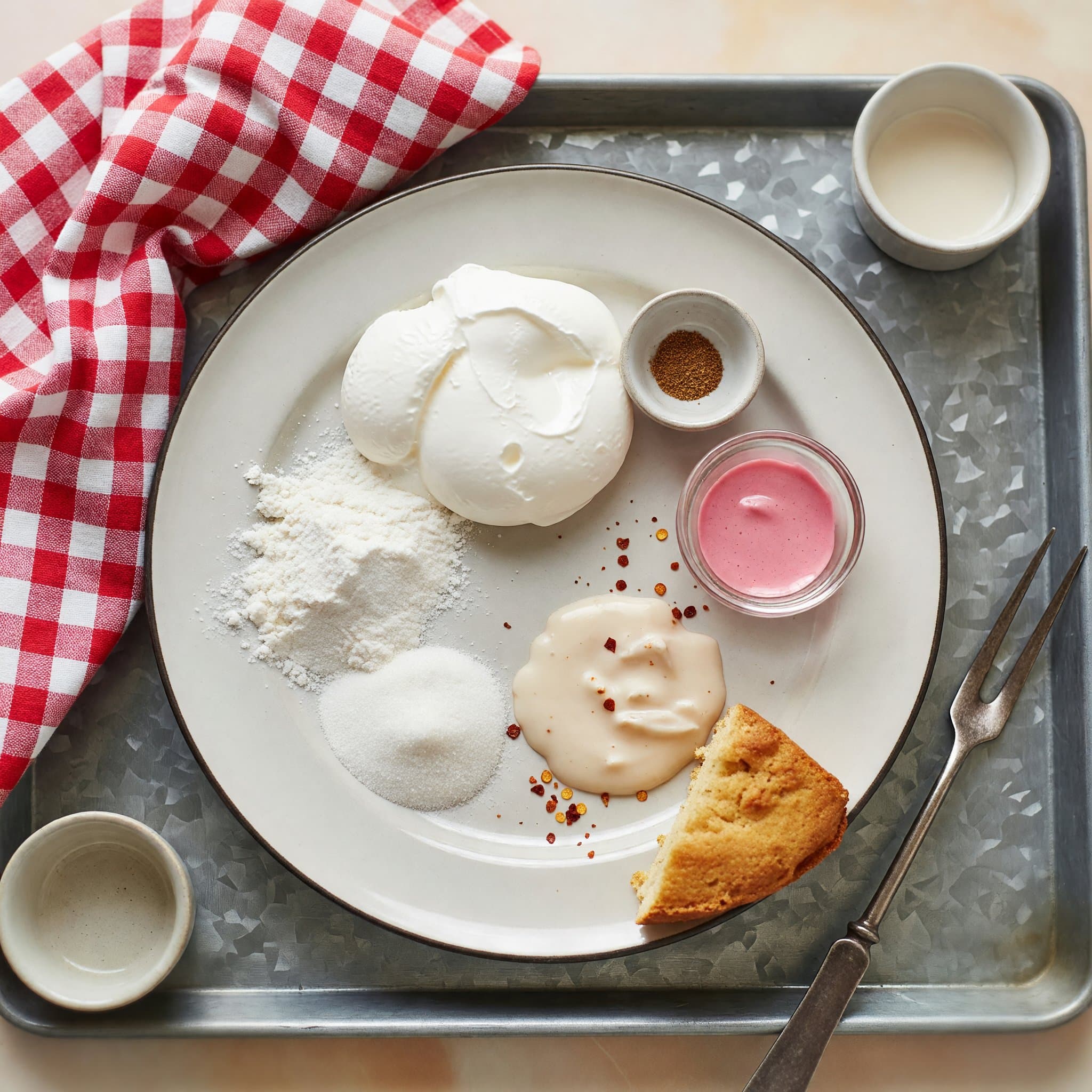 Overhead view of Egg Whites, Cornstarch, Sugar and Pink Food Coloring arranged on a table