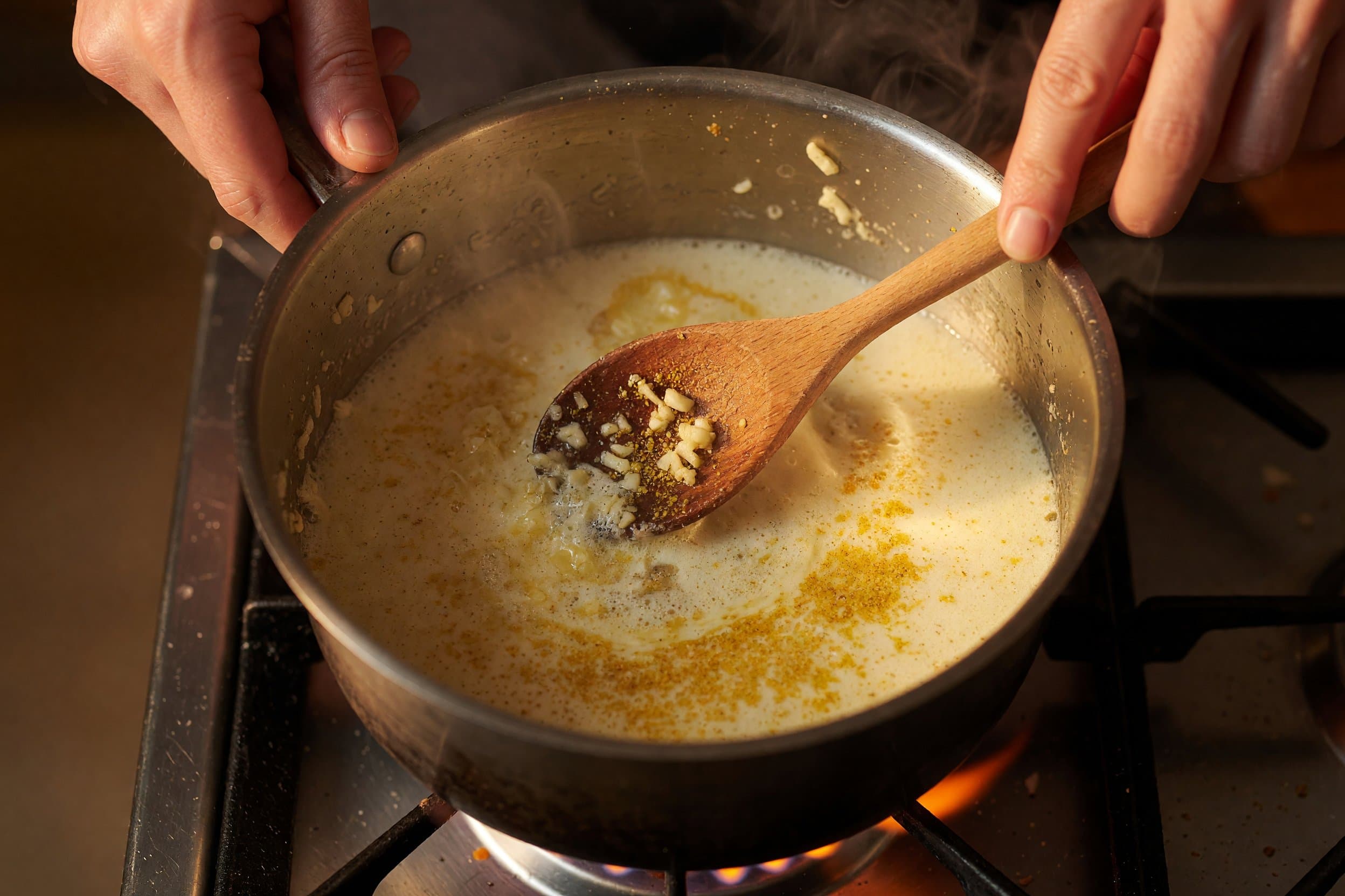 Stirring garlic and seasonings in butter while preparing One Pot Garlic Parmesan Mac & Cheese