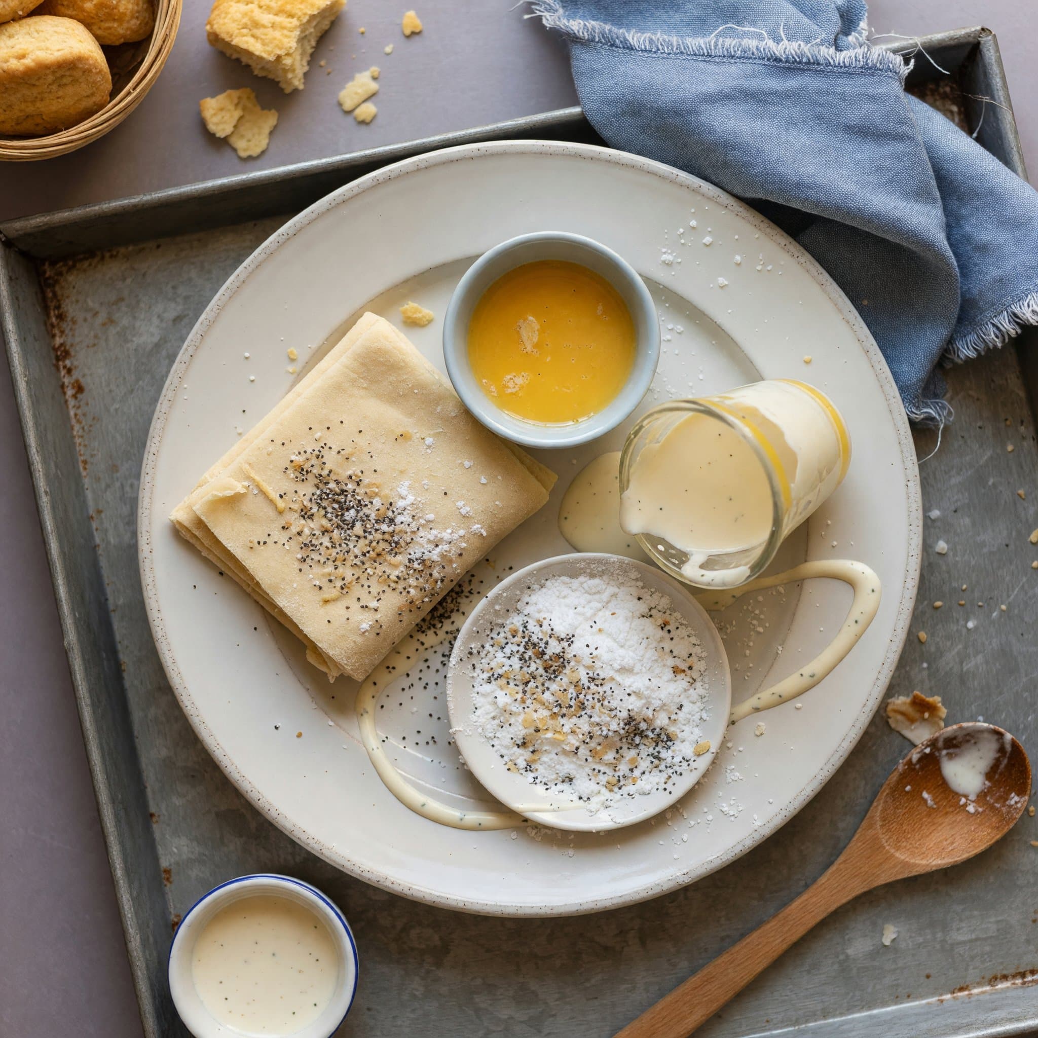 Overhead view of Puff Pastry, Egg Wash, Heavy Cream and Powdered Sugar arranged on a table