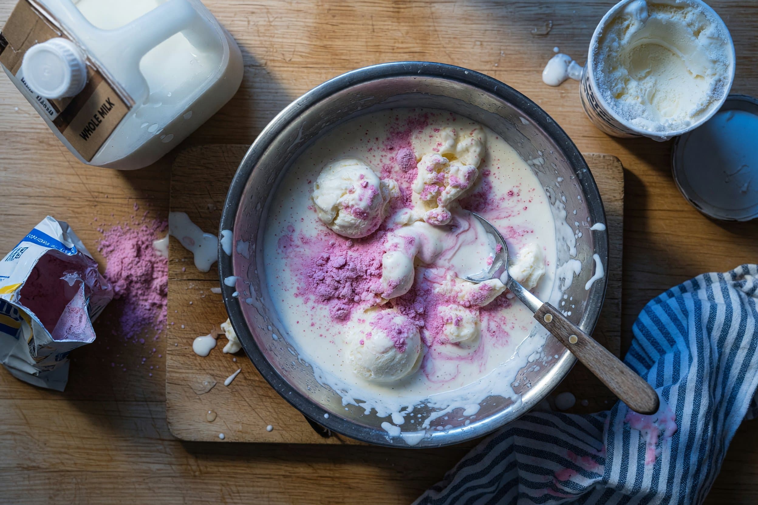 Stirring vanilla ice cream, milk, and Nesquik powder while preparing Perfect Copycat Wendys Frosty