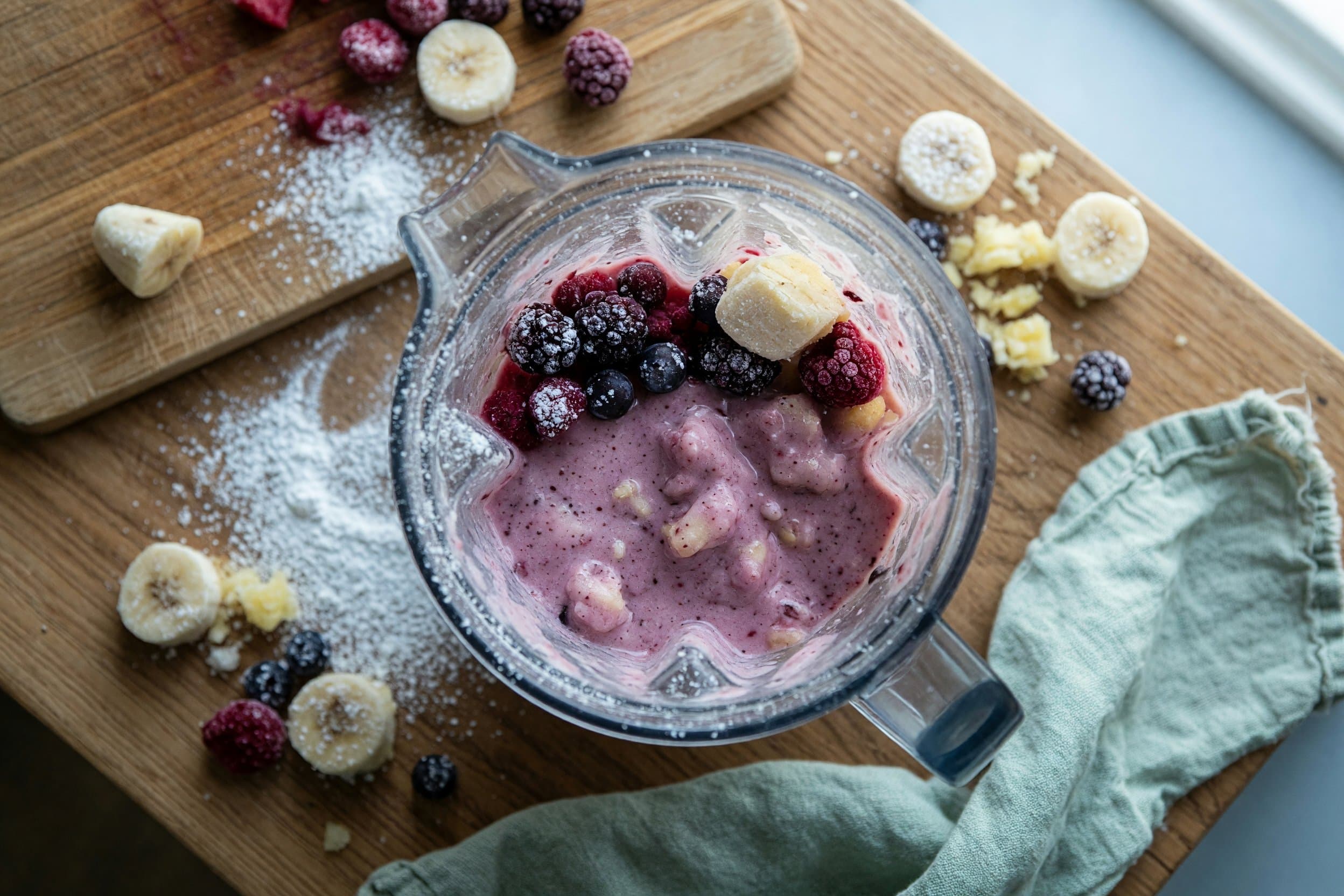 Stirring frozen bananas, pineapple, and berries while preparing Mixed Berry Dole Whip