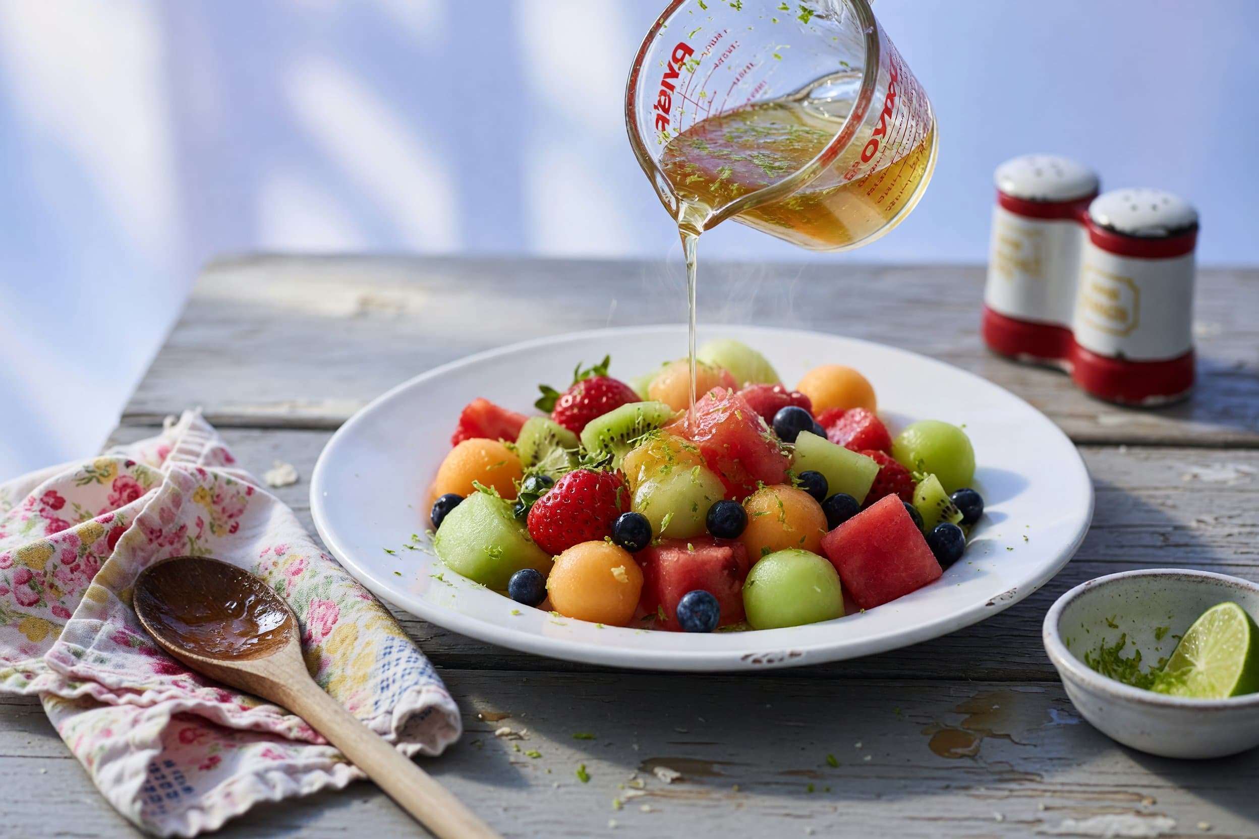 In a measuring cup, combine your honey, lime zest, and fresh lime juice, and mix while preparing The Best Ever Fruit Salad Recipe