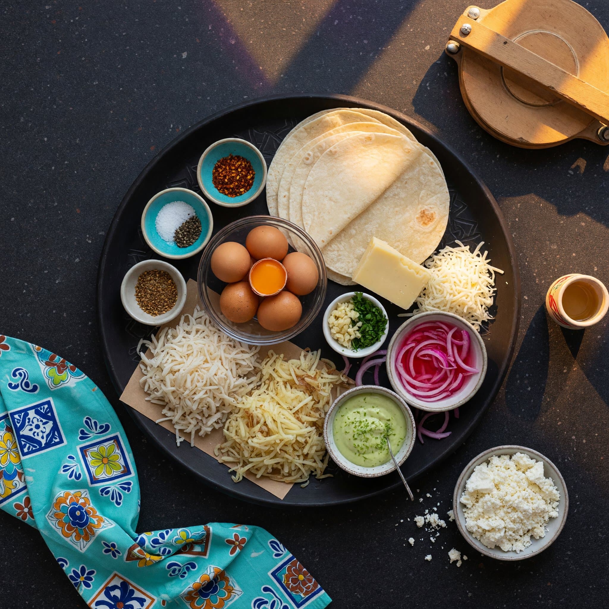 Overhead view of Flour Tortillas, Eggs, Cheese and Hash Browns arranged on a table