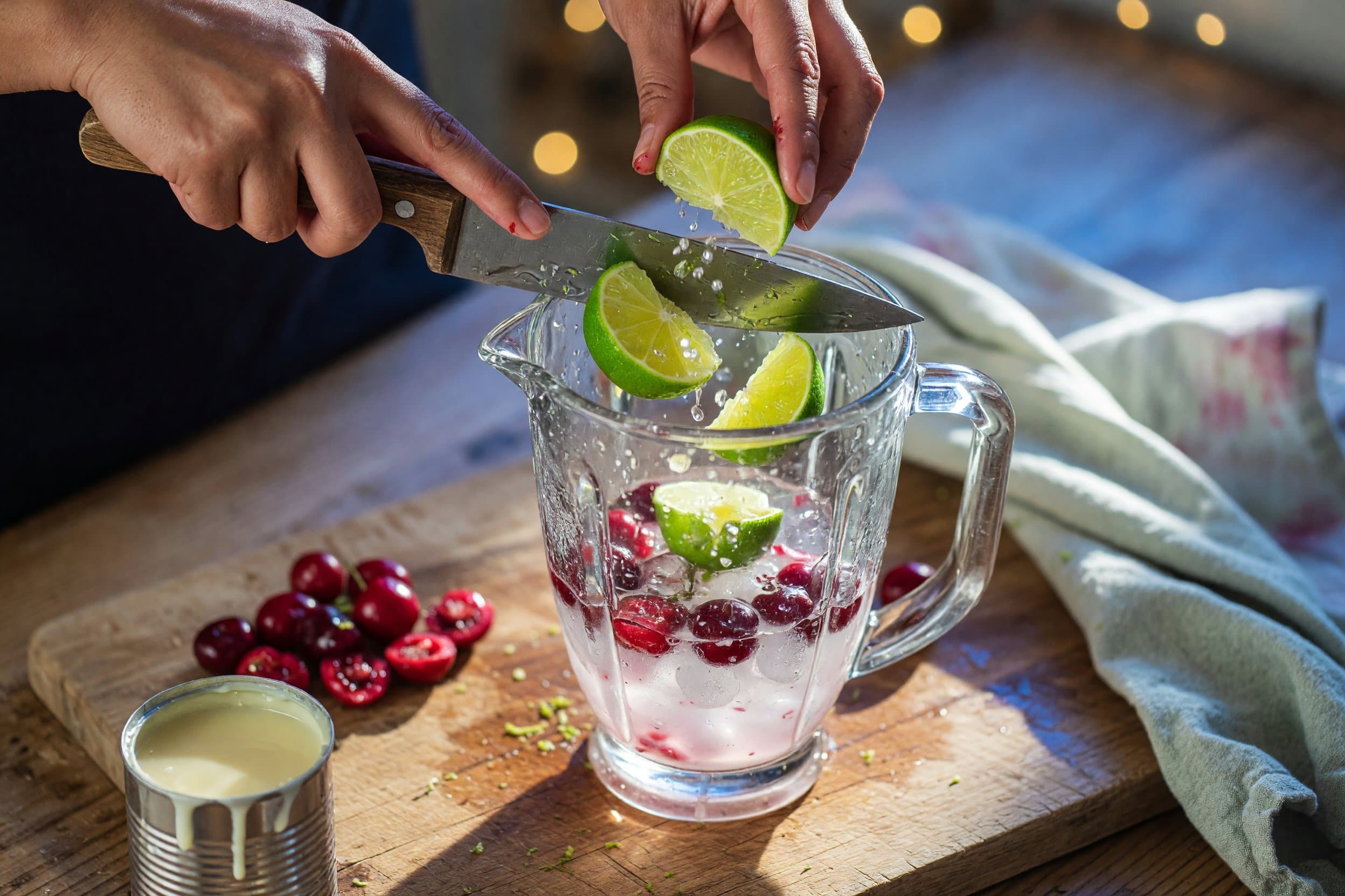 Chopping fresh limes while preparing Cherry Brazilian Limeade