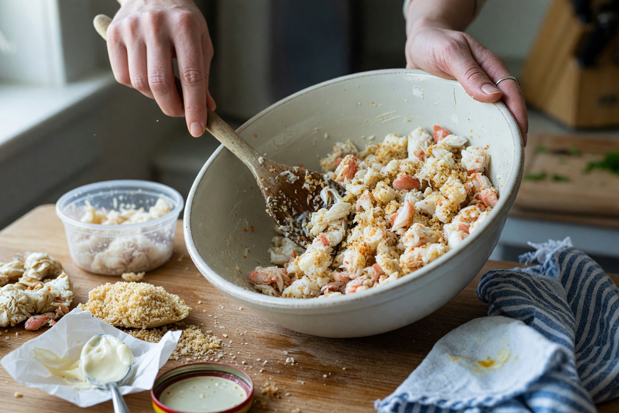 Folding crab meat mixture while preparing Baltimore-Style Crab Cakes