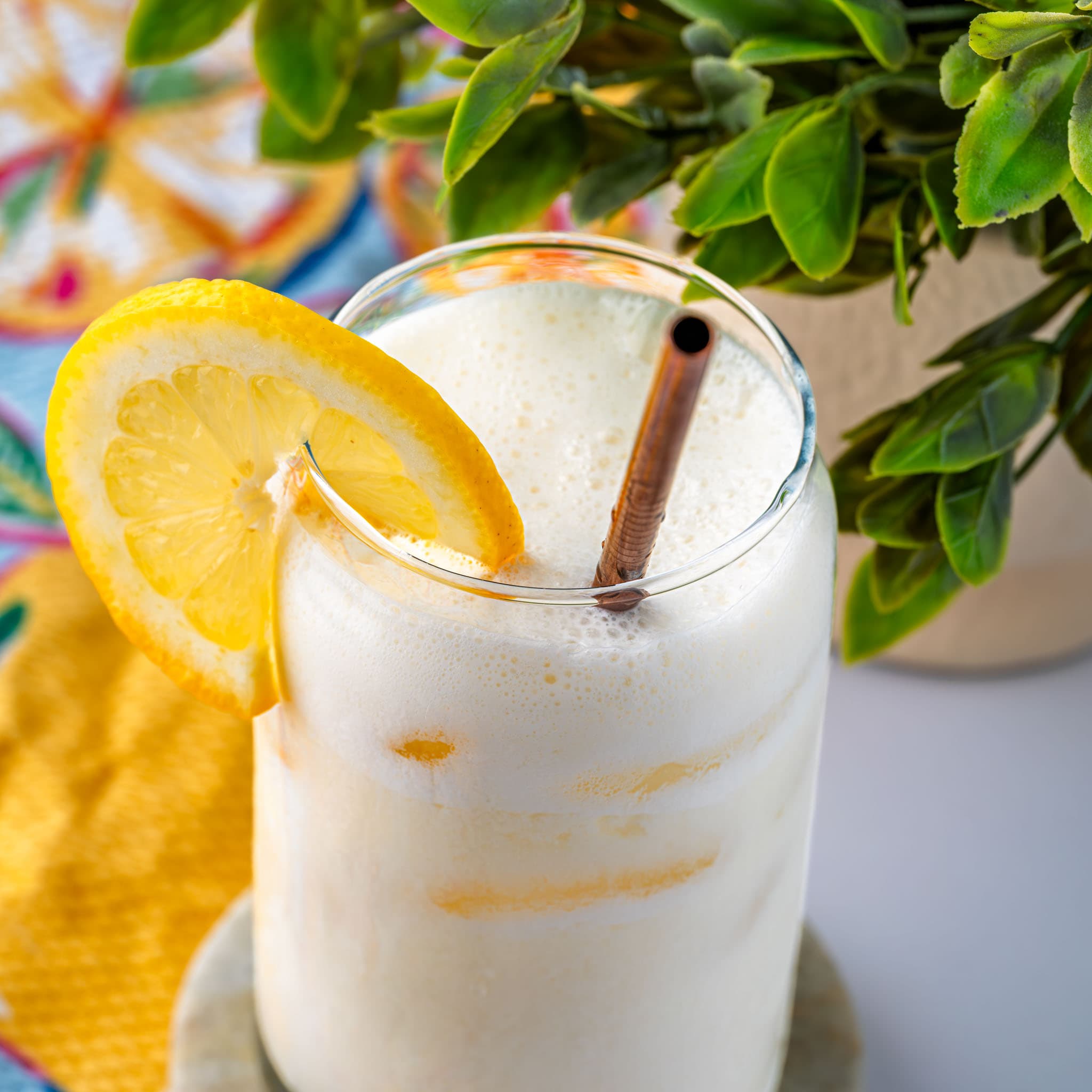 A tall glass of creamy lemonade over ice, sweating in the Florida sun.
