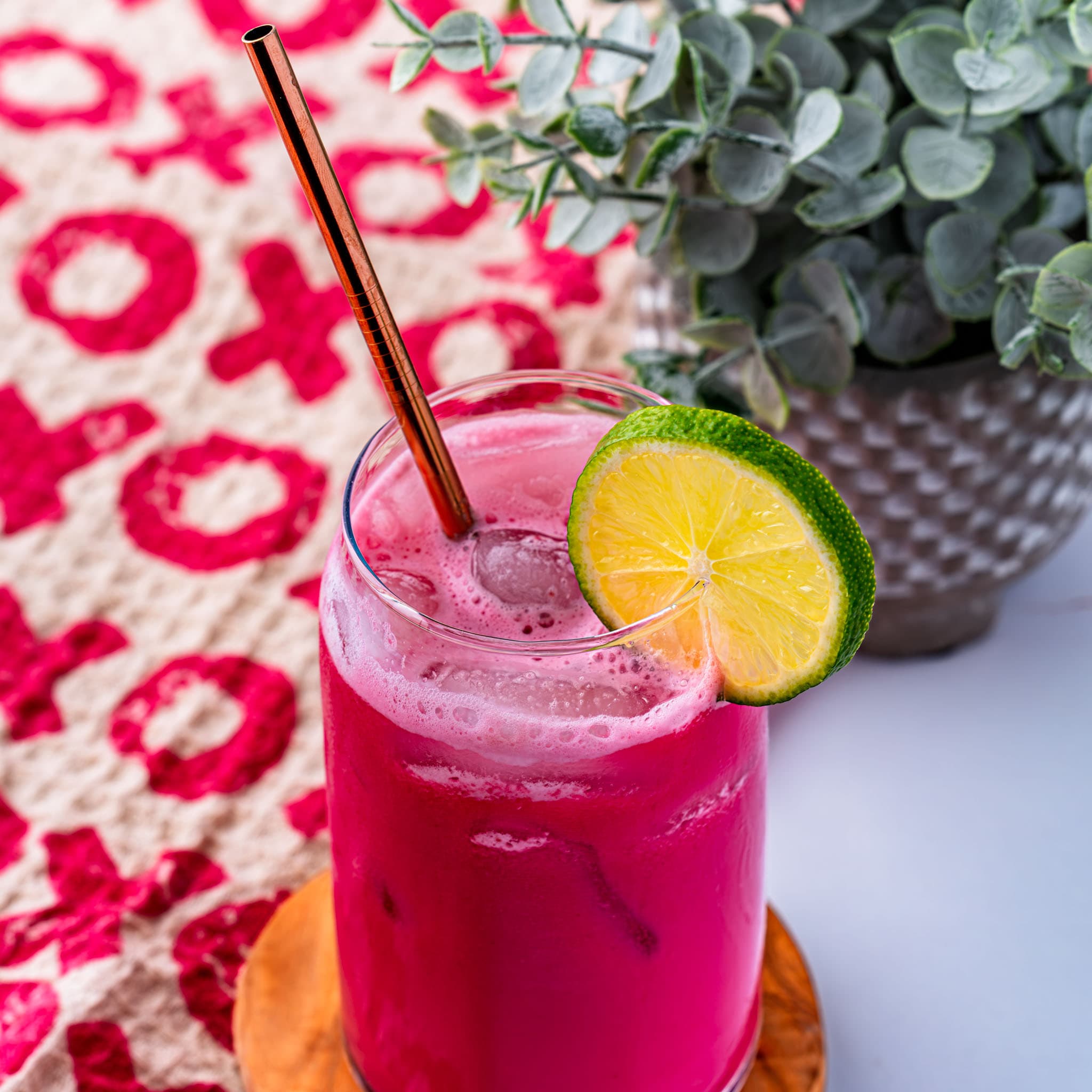 A frothy, bright pink Cherry Brazilian Limeade served over ice.