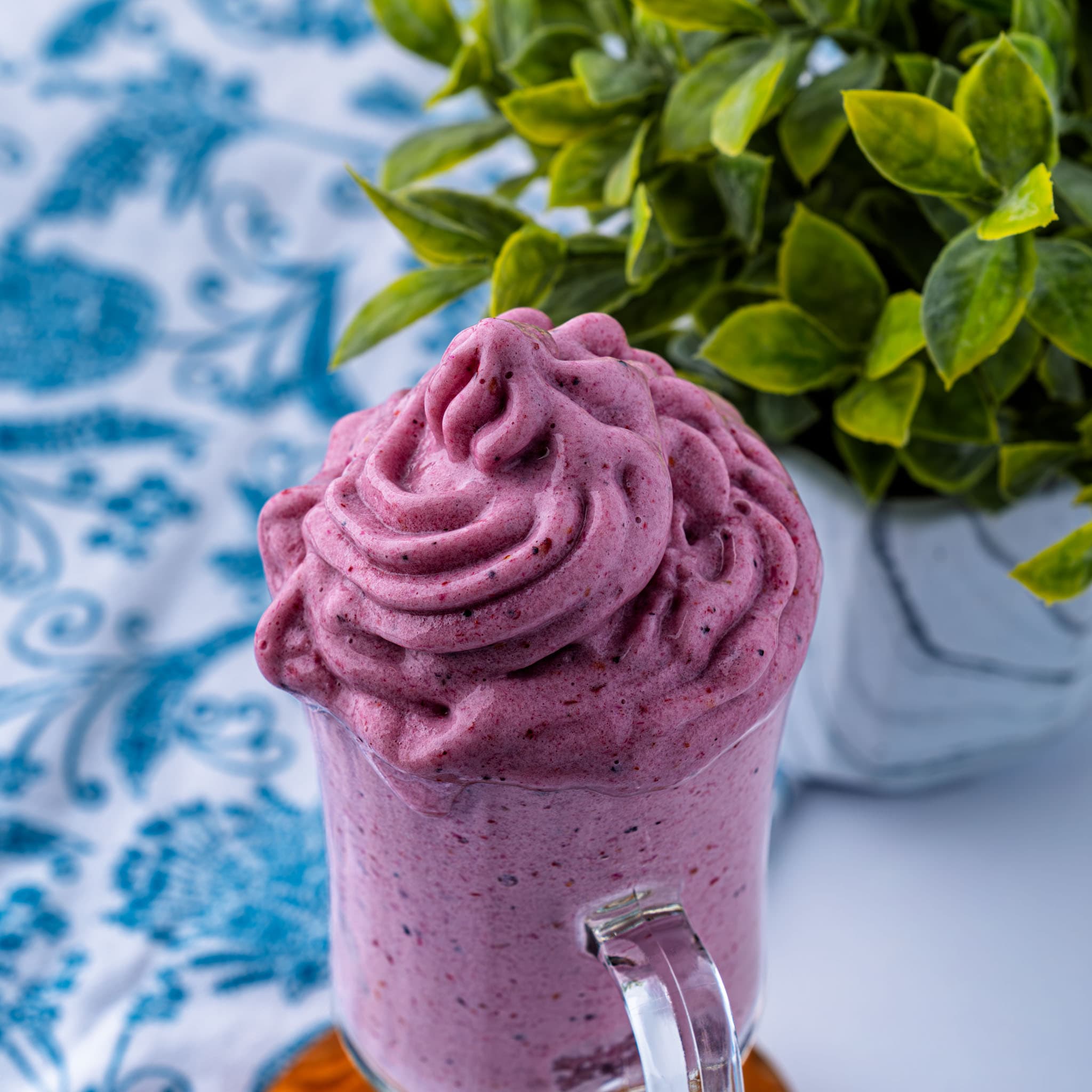 Swirls of berry soft serve piled high in a bowl, fresh off the blender.