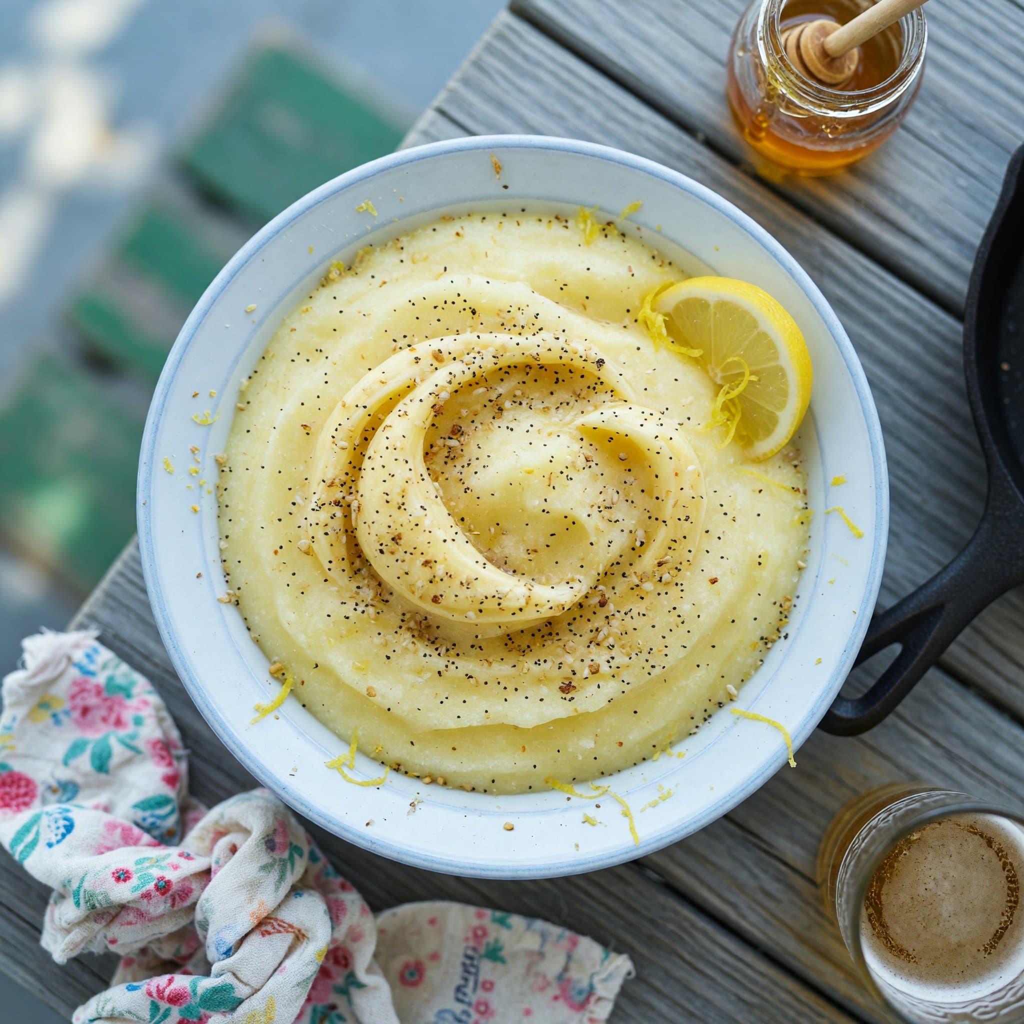 A frosty glass of blended lemonade, thick enough to need a spoon.