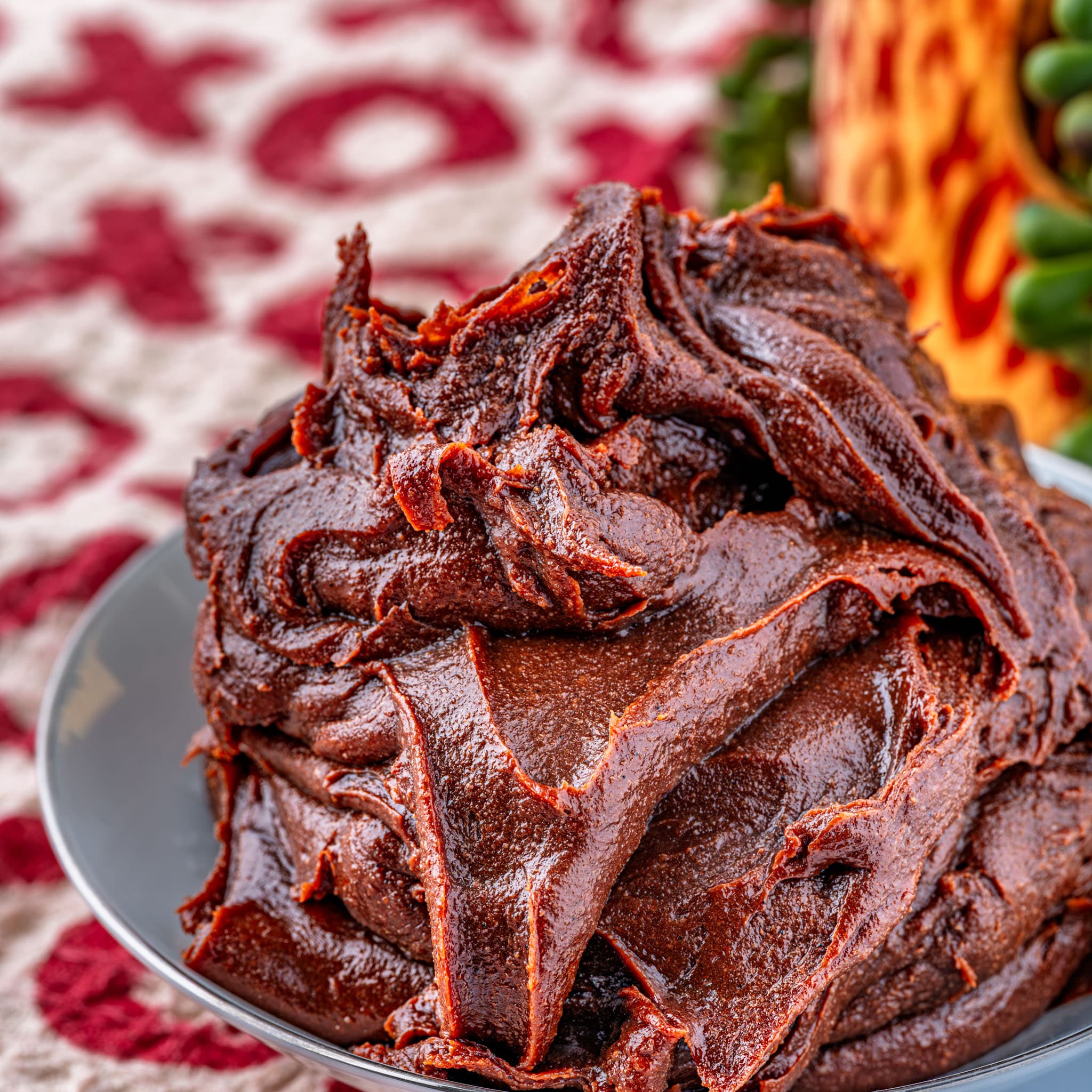 Smooth, glossy homemade Nutella spread thick on a slice of toast — the real deal, made right in your kitchen.