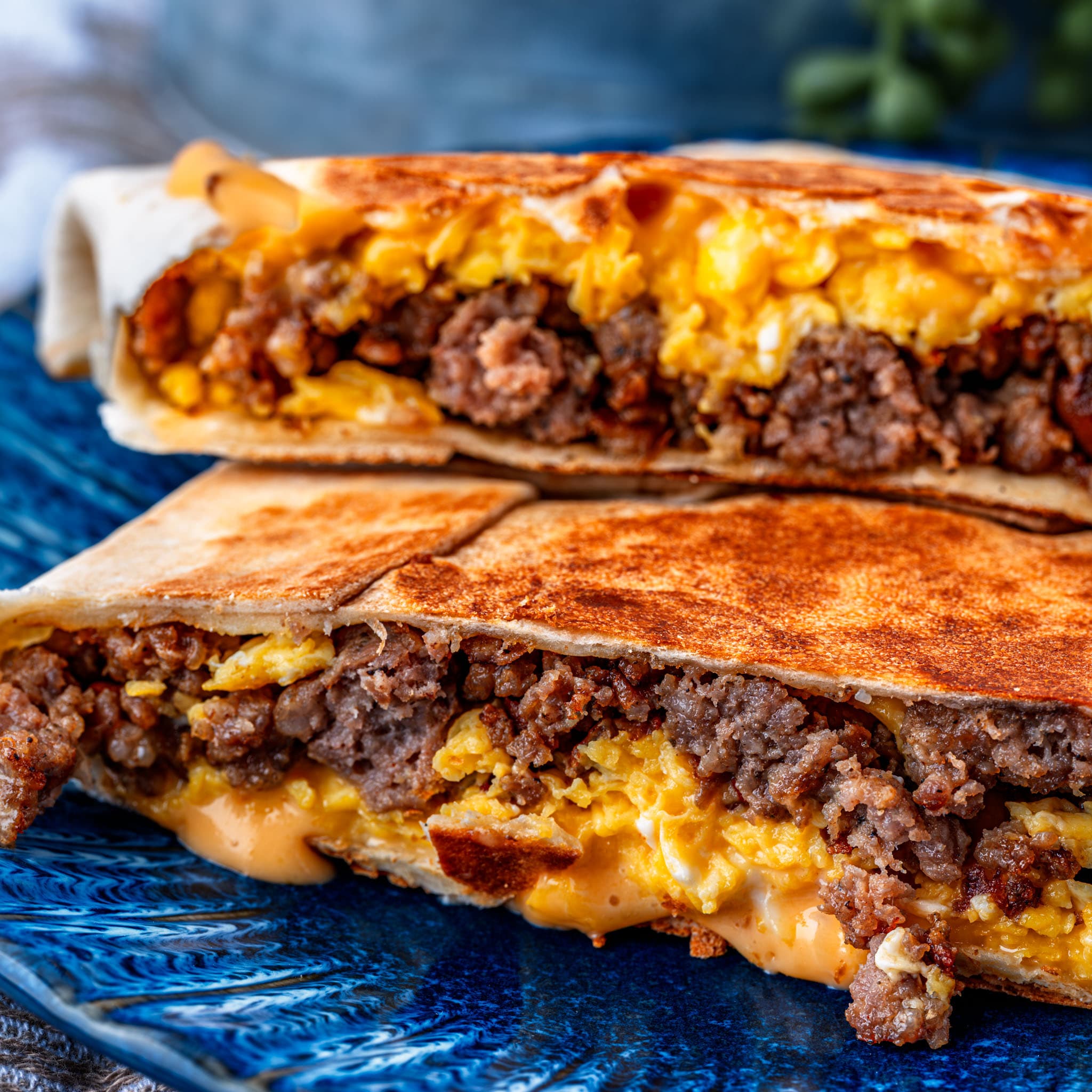 Golden, crispy breakfast crunchwraps fresh off the skillet — sausage, egg, and cheese all wrapped up tight.