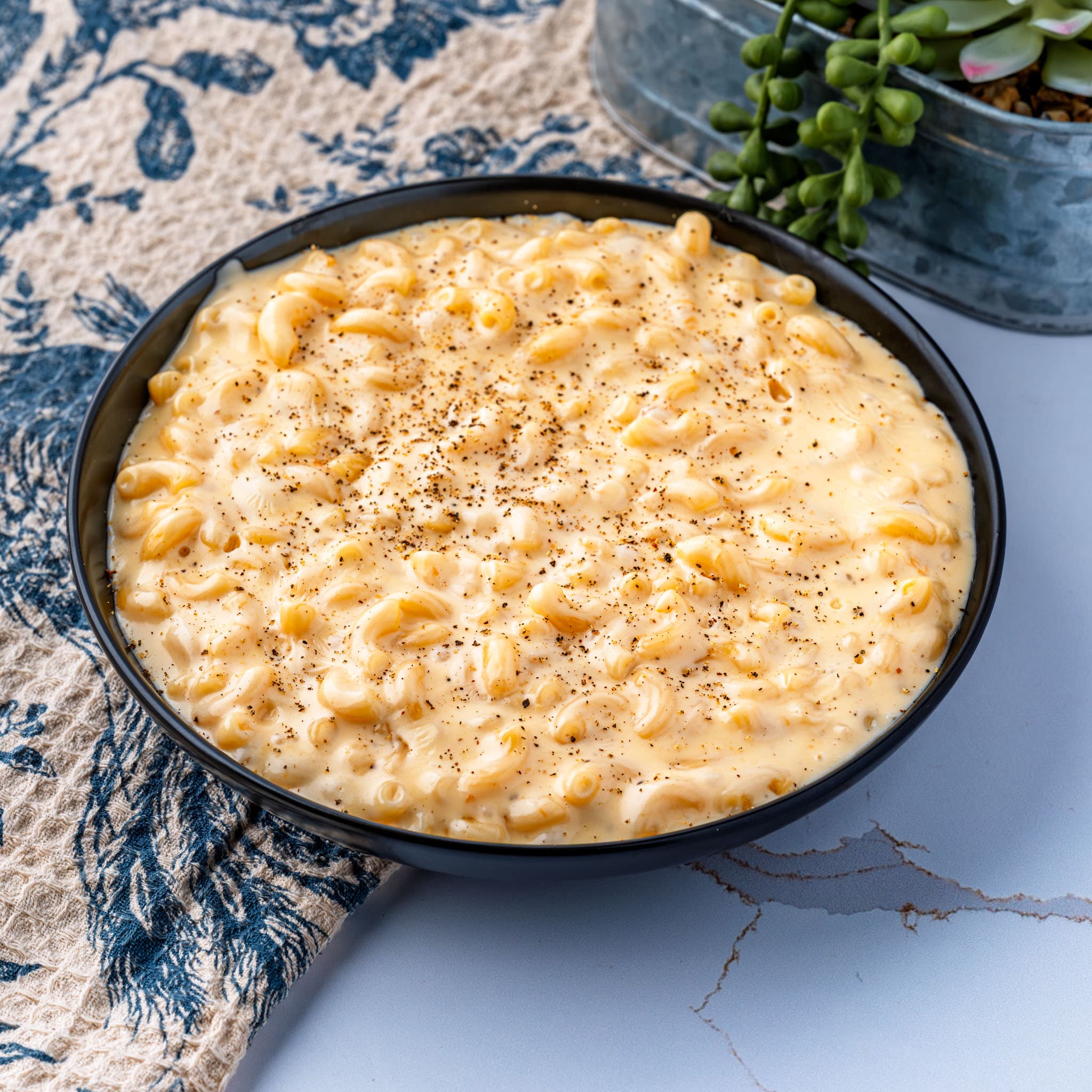 A bowl of smoked gouda mac and cheese, sauce clinging to every noodle.