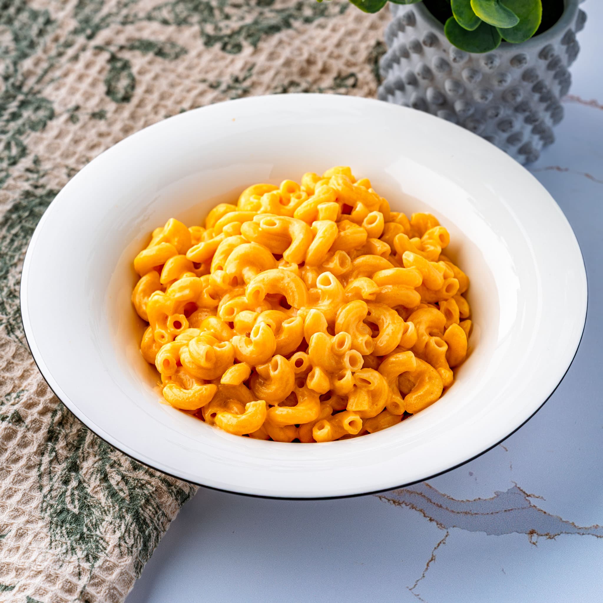A skillet of glossy stovetop mac and cheese, straight off the heat.
