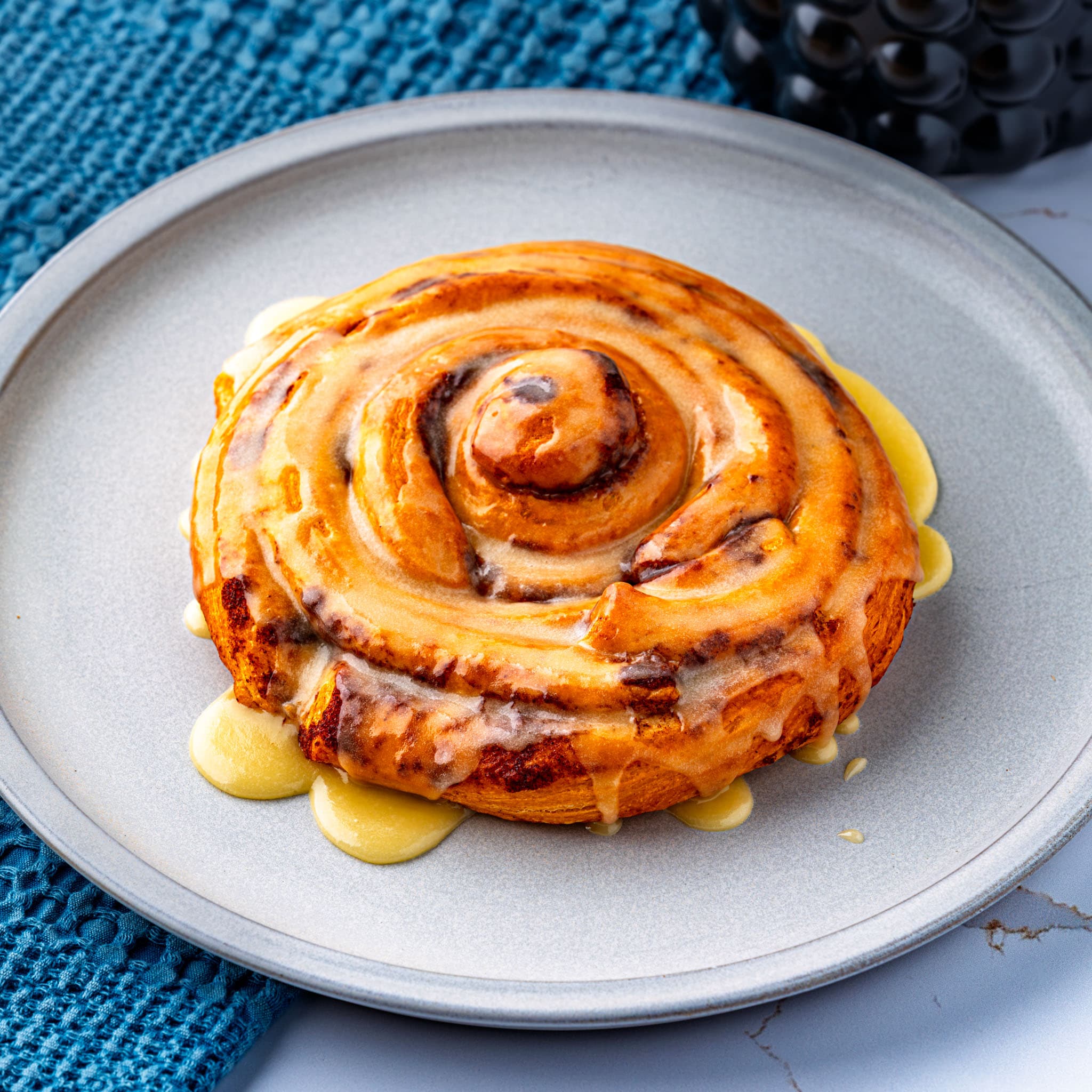 The finished giant cinnamon roll, glazed and sliced like a cake.