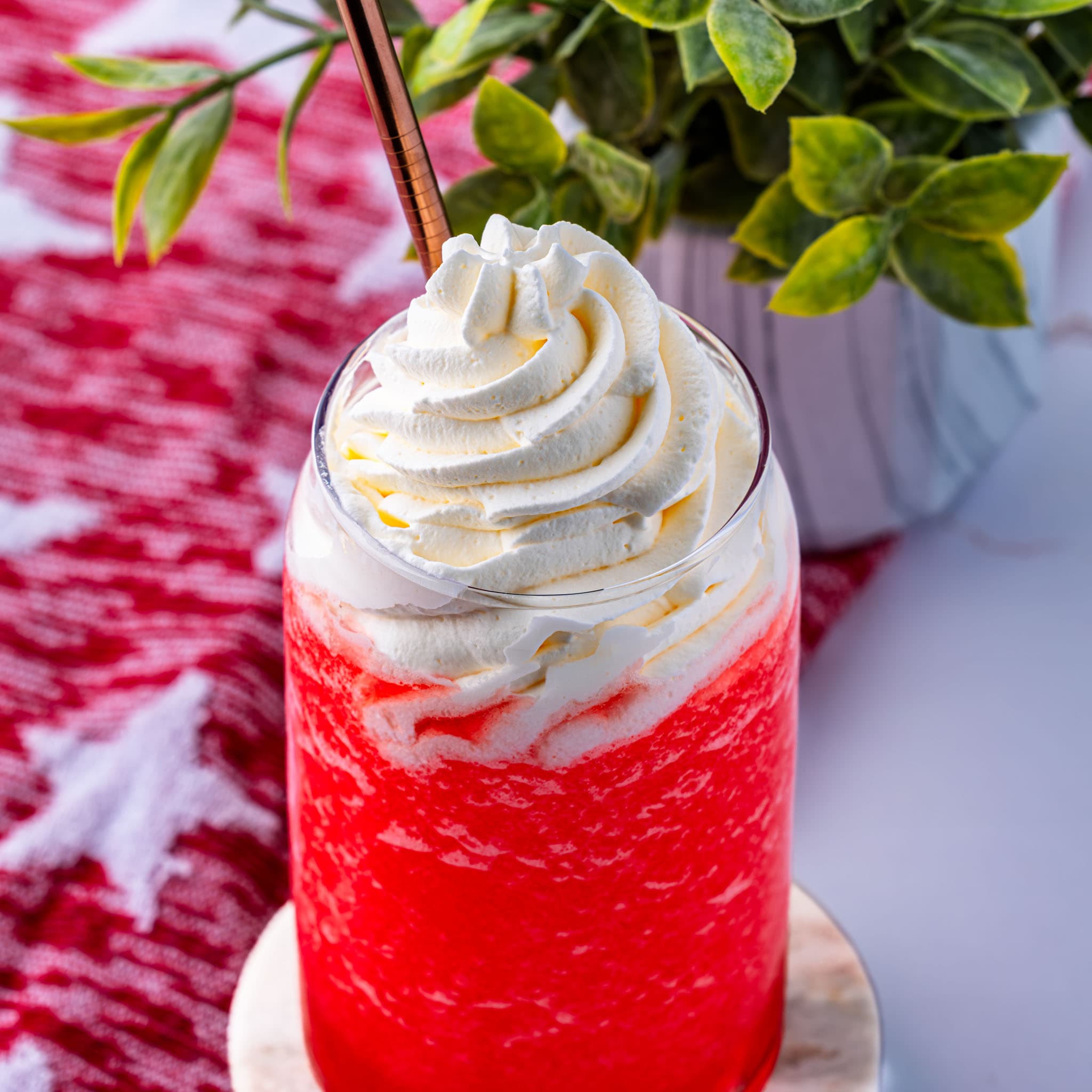 A frosty pink-gold slush in a glass, straight from the blender.