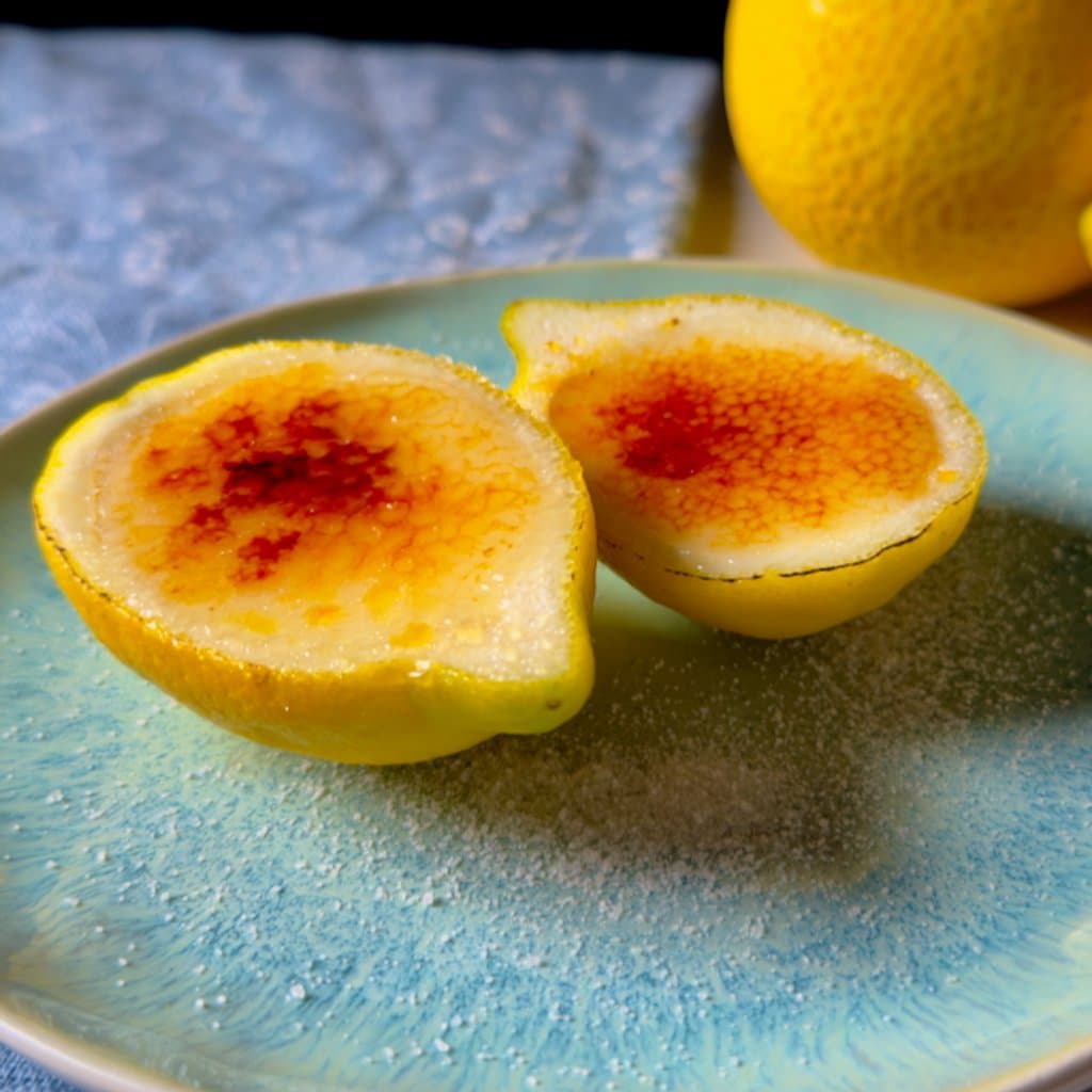 Lemon posset served in hollowed lemon shells with a caramelized sugar topping — elegant and effortless.
