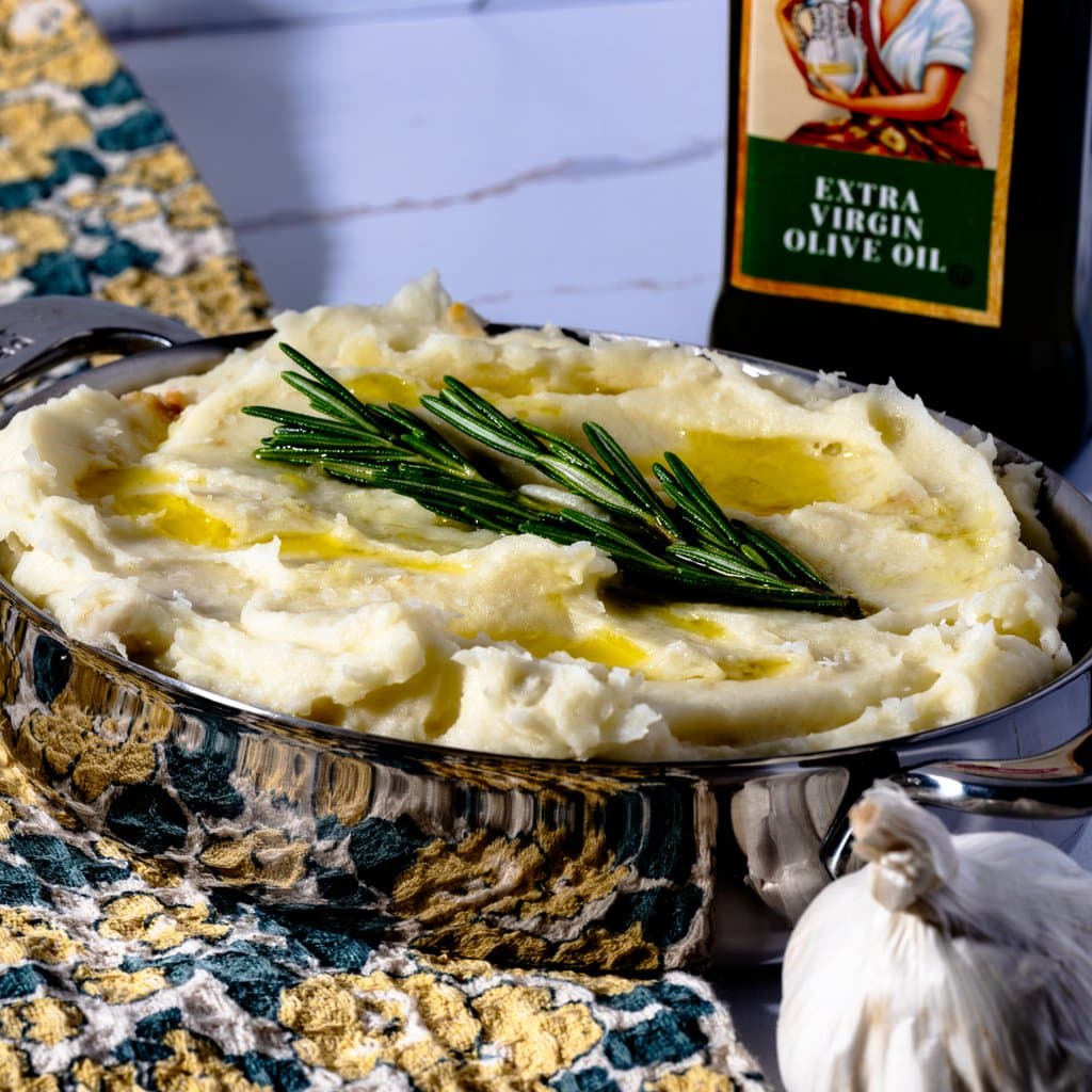 Garlic roasted olive oil mashed potatoes topped with fresh rosemary and a drizzle of EVOO.