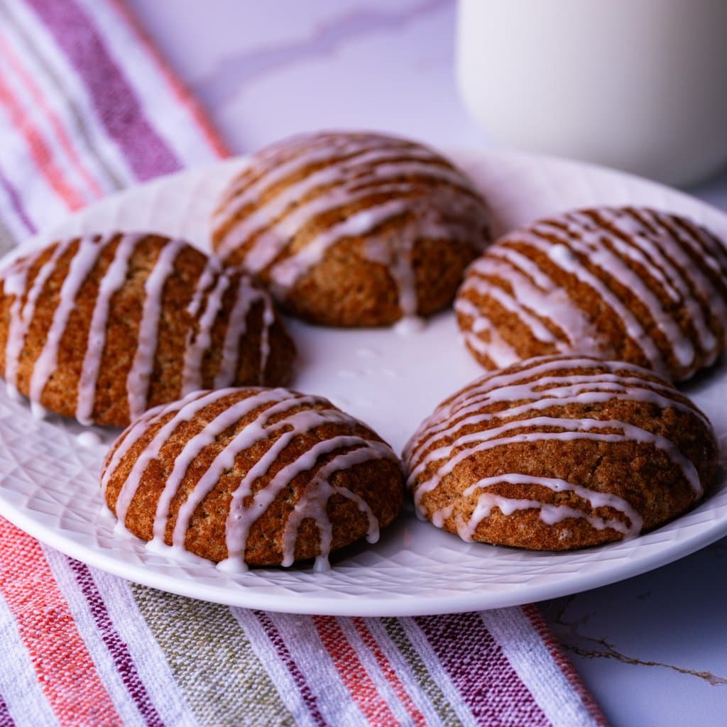 Spiced apple cider cookies glazed and ready to go — chewy centers, warm spice, and that glossy icing finish.