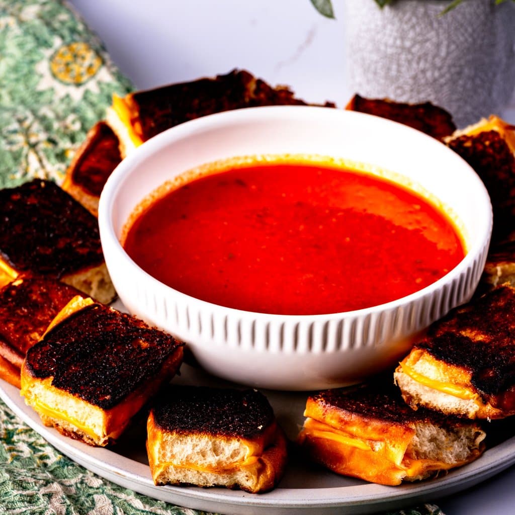 Bite-sized grilled cheese made with King's Hawaiian rolls, golden and crispy, served with a bowl of tomato soup for dunking.