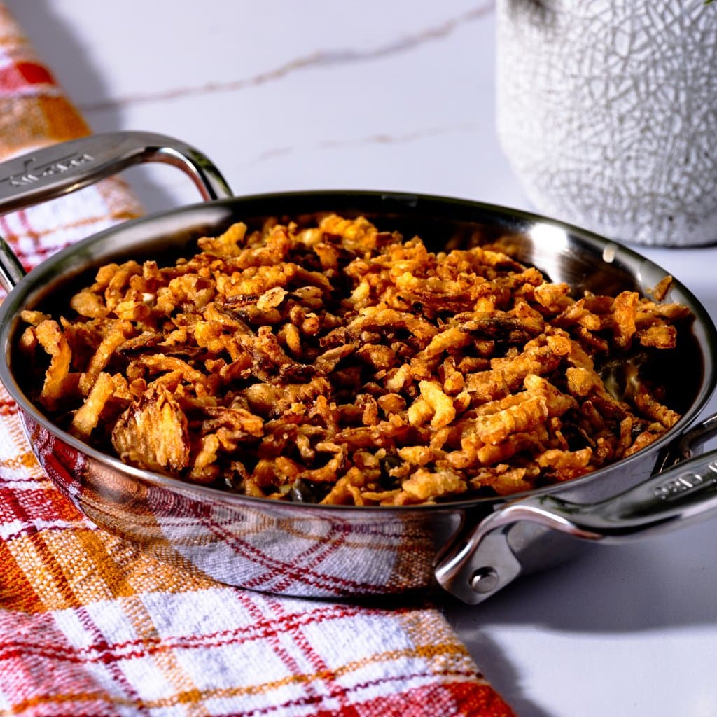 Classic green bean casserole fresh from the oven, golden crispy onions on top.